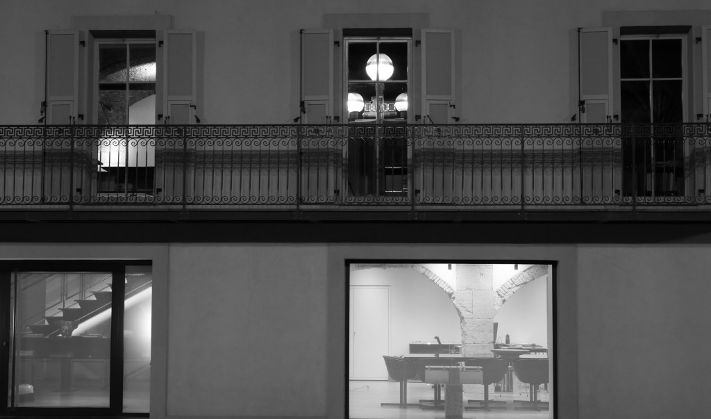 A photograph titled Windows and fantasies with 3 windows in the balcony.